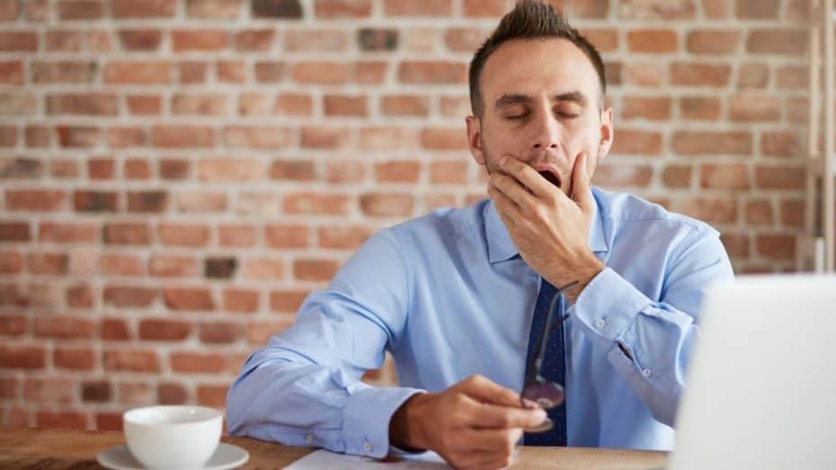 businessman in tie yawning