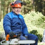 Logger with chainsaw in the forest